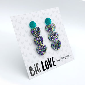 Pair of glittery heart-shaped earrings on a 'BIG LOVE just for you' card.