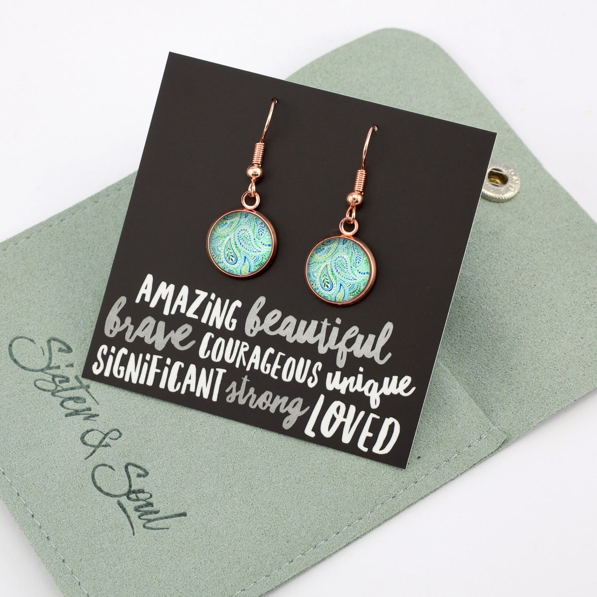 Teal paisley print rose gold dangle earrings on amazing inspiring word card on white background. With green coloured gift pouch. 