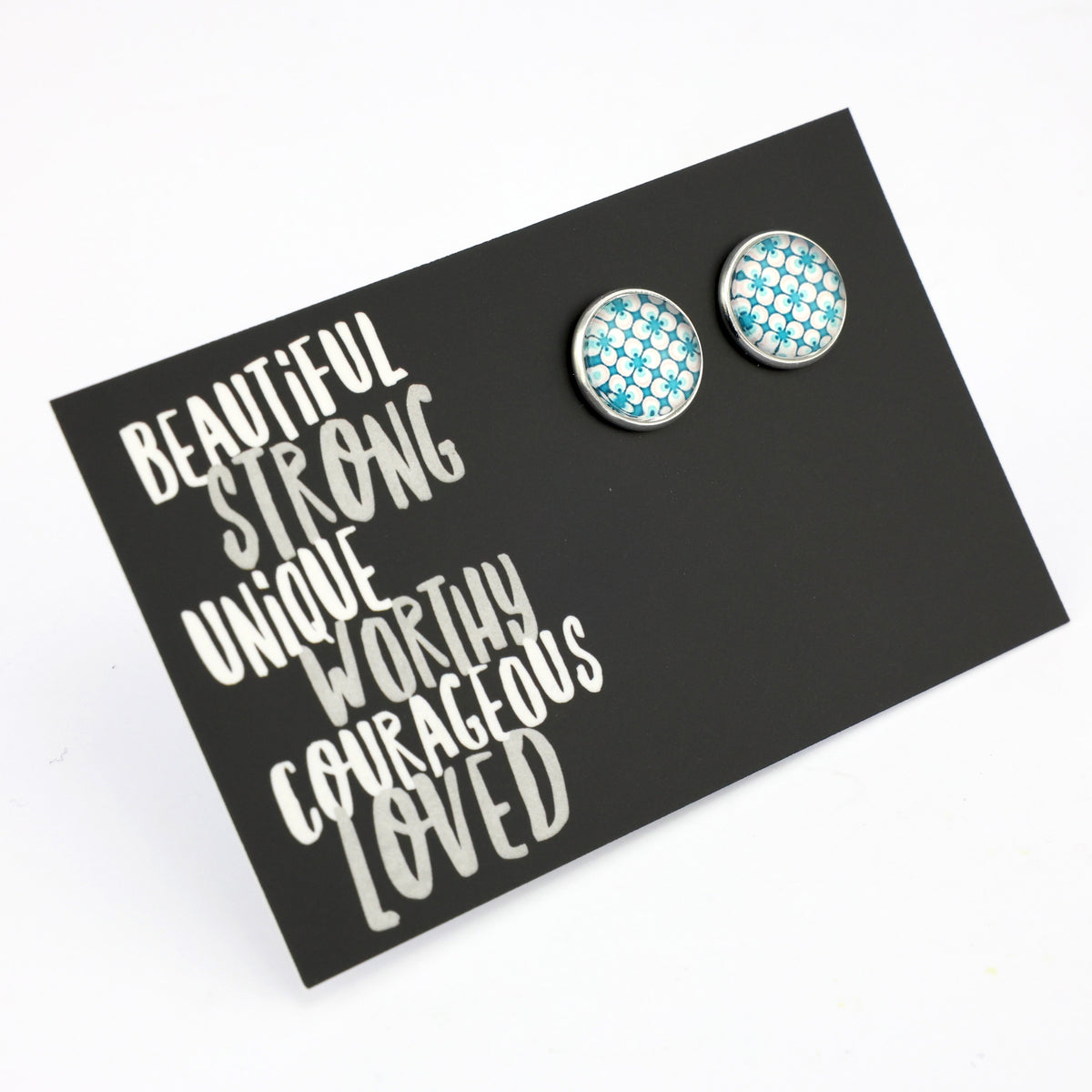 Teal print silver stud earrings on beautiful inspiring word card on white background.