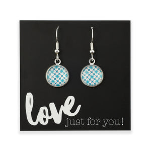 Teal print silver dangle earrings on love and inspiring word card on white background.