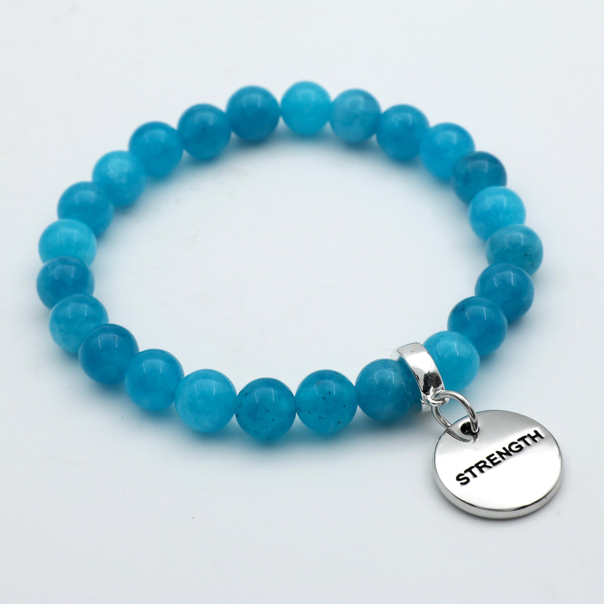 Blue beaded bracelet with a 'STRENGTH' charm on a light gray background