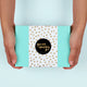 Person holding a turquoise box with a gold polka dot label and 'you are amazing' text.