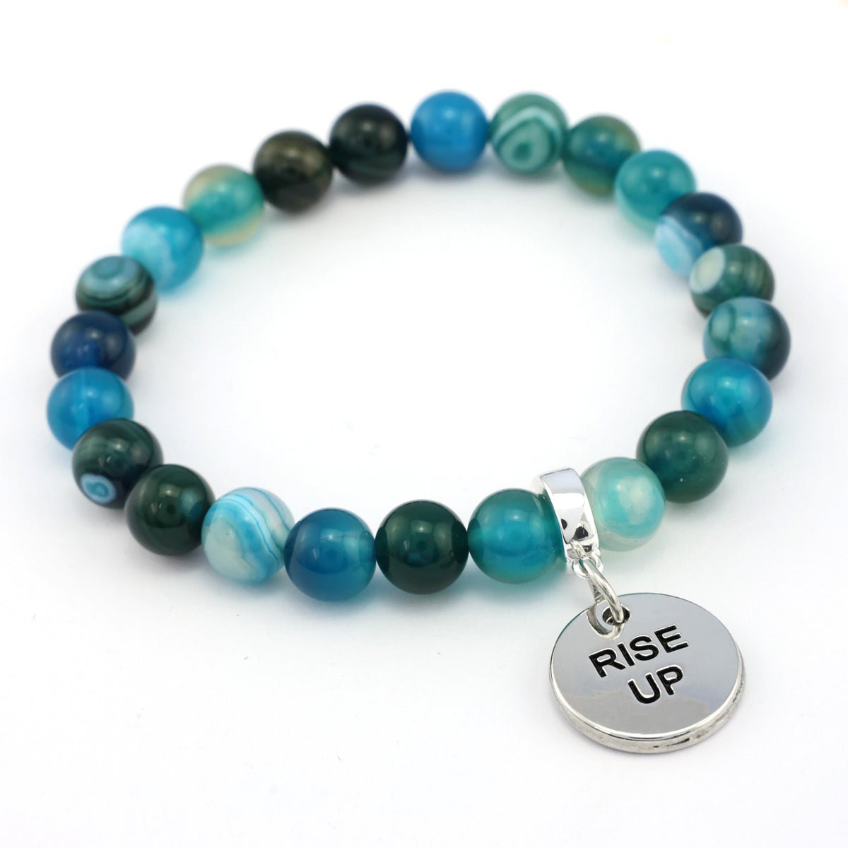 Beaded bracelet with 'RISE UP' charm on a white background