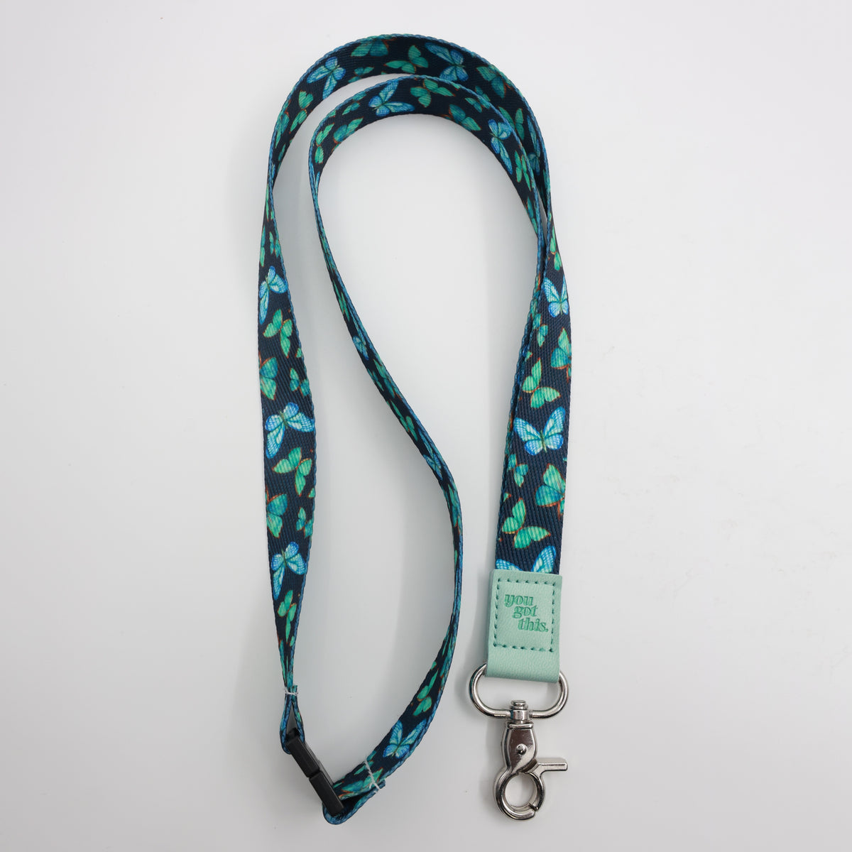 You Got This embossed on a navy lanyard with teal butterflies and mint trim and a lobster clasp.