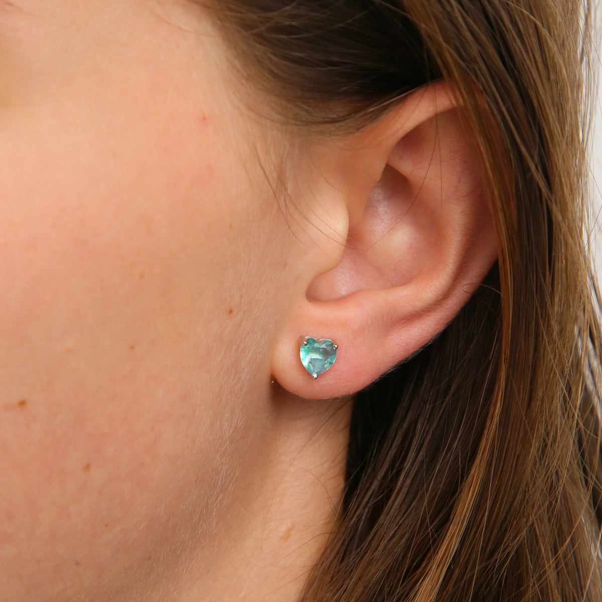 TEAL sterling silver heart with aqua coloured quartz earring studs, a product that raises funds for Ovarian cancer. Presented on an inspiring card that says strong beautiful and courageous. 