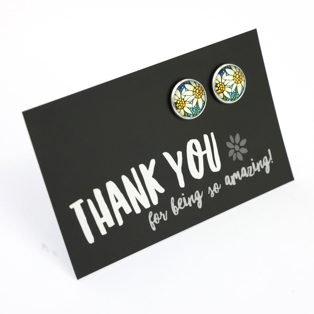 Floral earrings on a 'Thank you' card with a white background