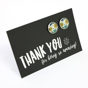 Floral earrings on a 'Thank you' card with a white background