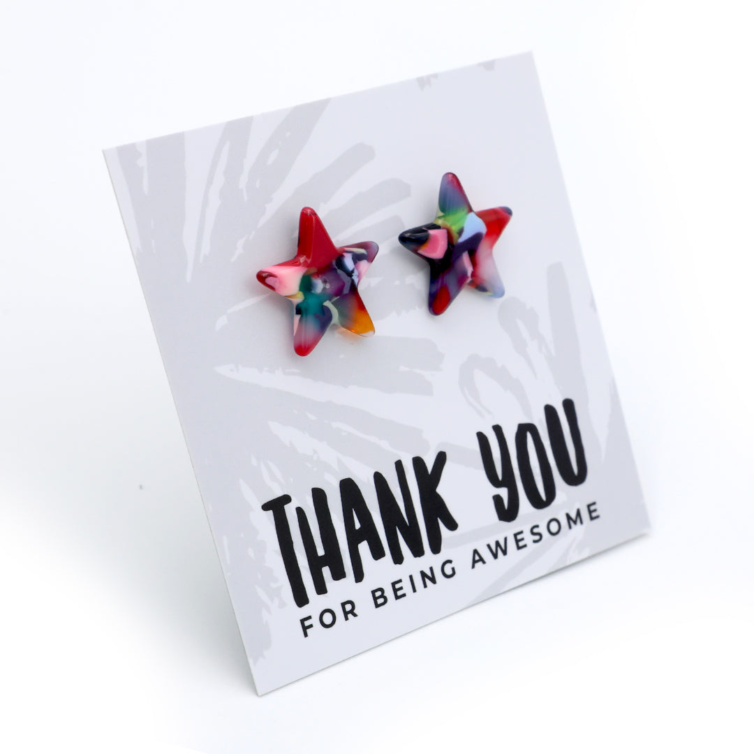 Two star-shaped stud earrings with a colorful marbled pattern in red, blue, green, and yellow, displayed on a white card that reads 'THANK YOU FOR BEING AWESOME' against a white background.