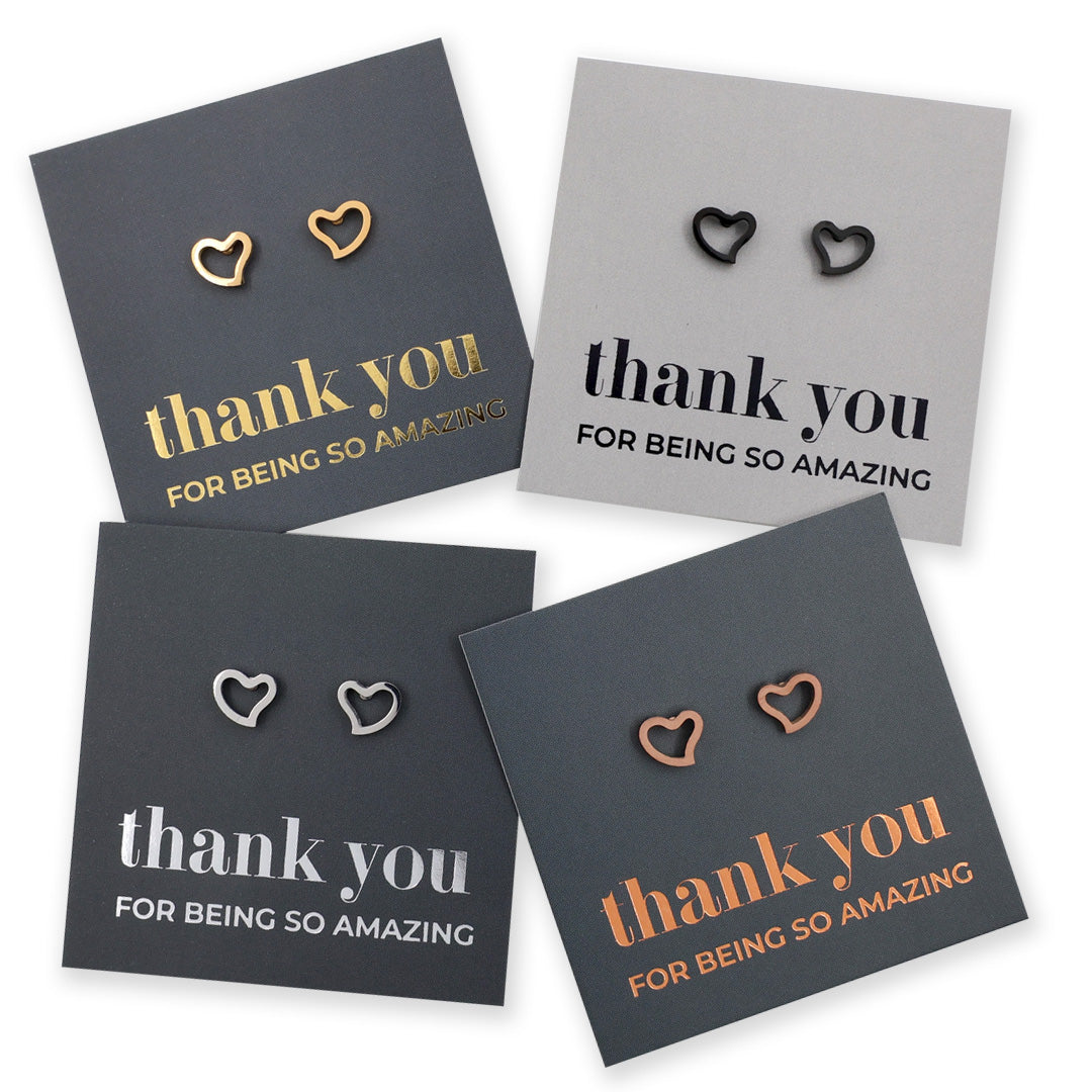 Four pairs of heart-shaped earrings on cards with 'thank you' messages.