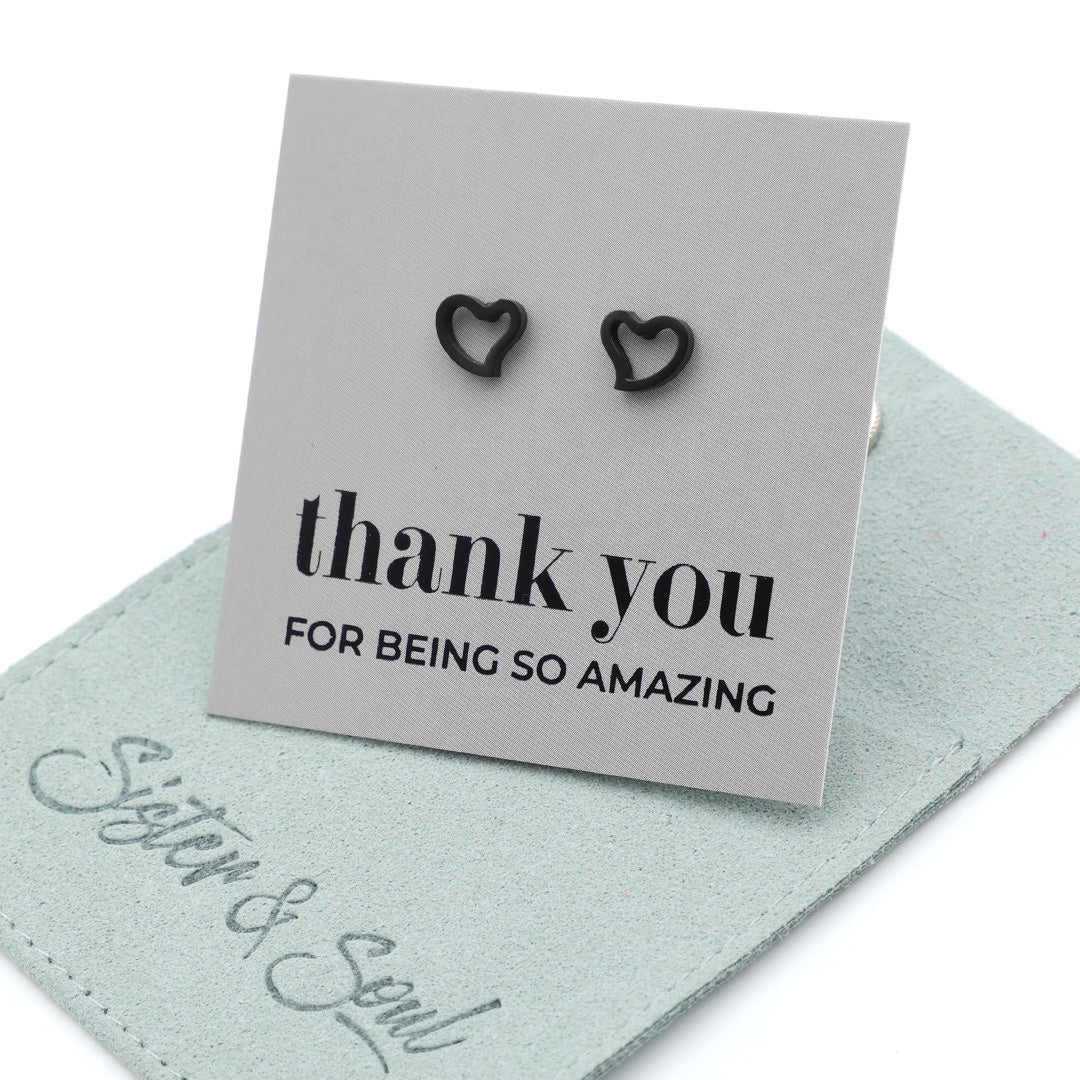 Heart-shaped earrings on a 'thank you' card with 'Sister & Soul' branding.