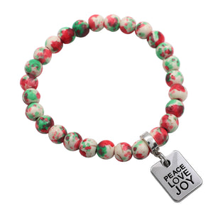 Beaded bracelet with 'Peace Love Joy' charm on a white background