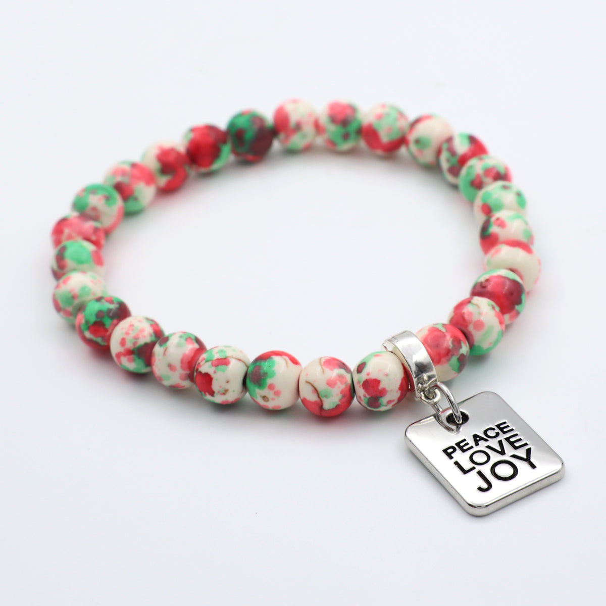 Beaded bracelet with 'Peace Love Joy' charm on a white background