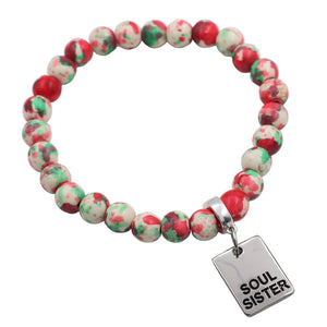 Bracelet with red, green, and white beads and a 'Soul Sister' tag on a light gray background