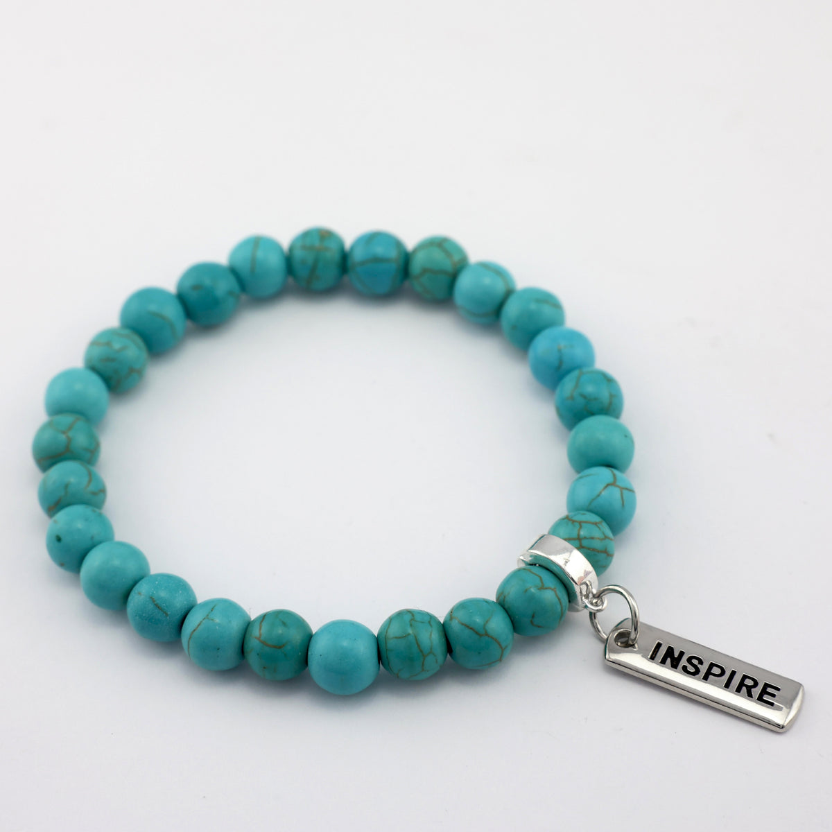 Turquoise beaded bracelet with a 'INSPIRE' charm on a white background