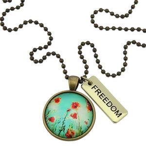 Necklace with floral pendant and 'FREEDOM' tag on a white background