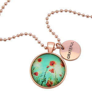 Necklace with floral pendant and 'GRATEFUL' tag on a white background