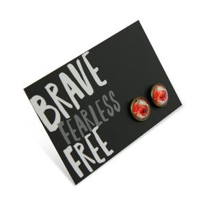 Pair of earrings on a card with 'Brave Fearless Free' text