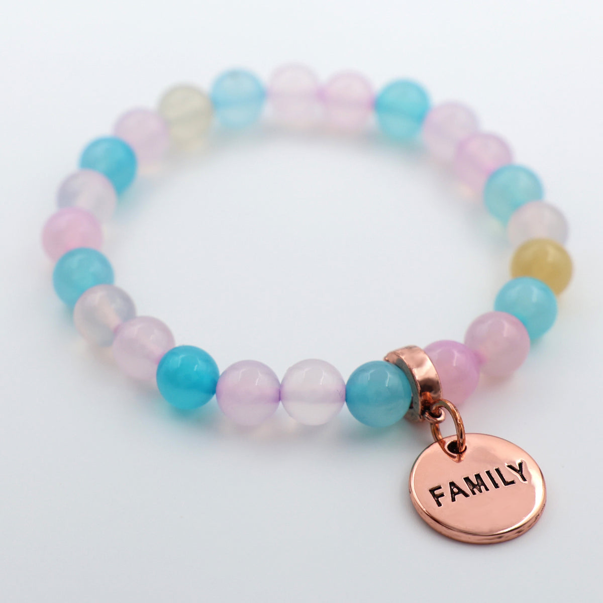 Multicolored beaded bracelet with a 'FAMILY' charm on a white background