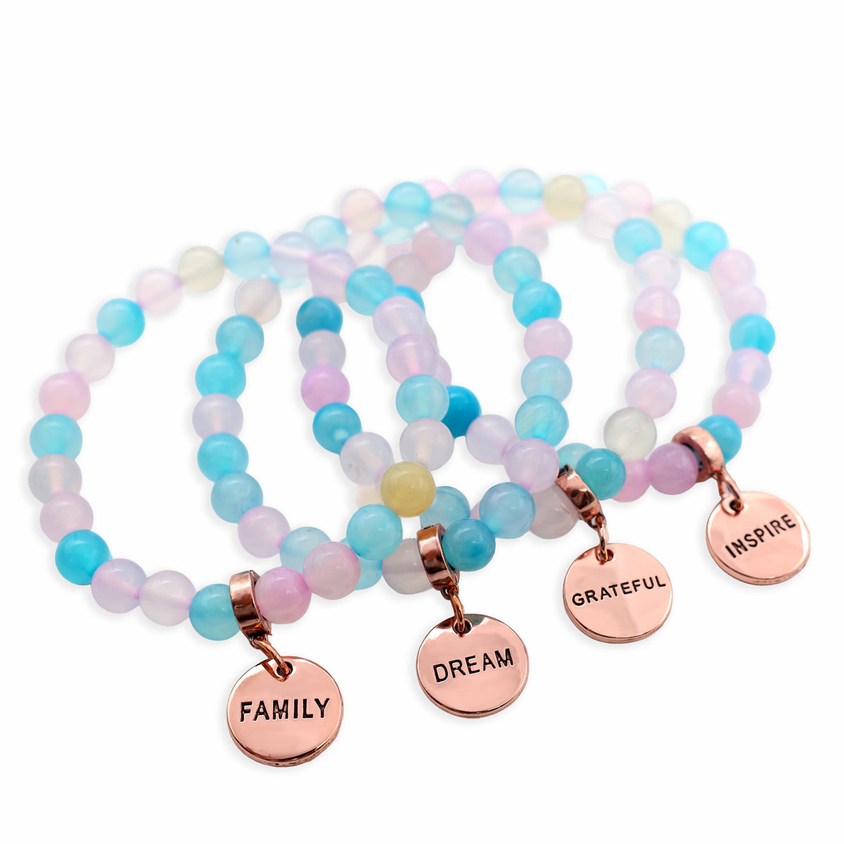 Set of colorful beaded bracelets with rose gold charms on a white background