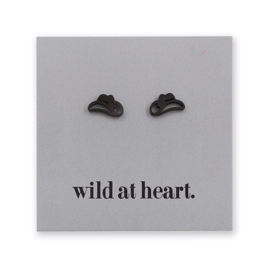 Black cowgirl hat earrings on a black card with 'wild at heart.' text.