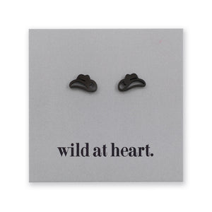 Black cowgirl hat earrings on a black card with 'wild at heart.' text.