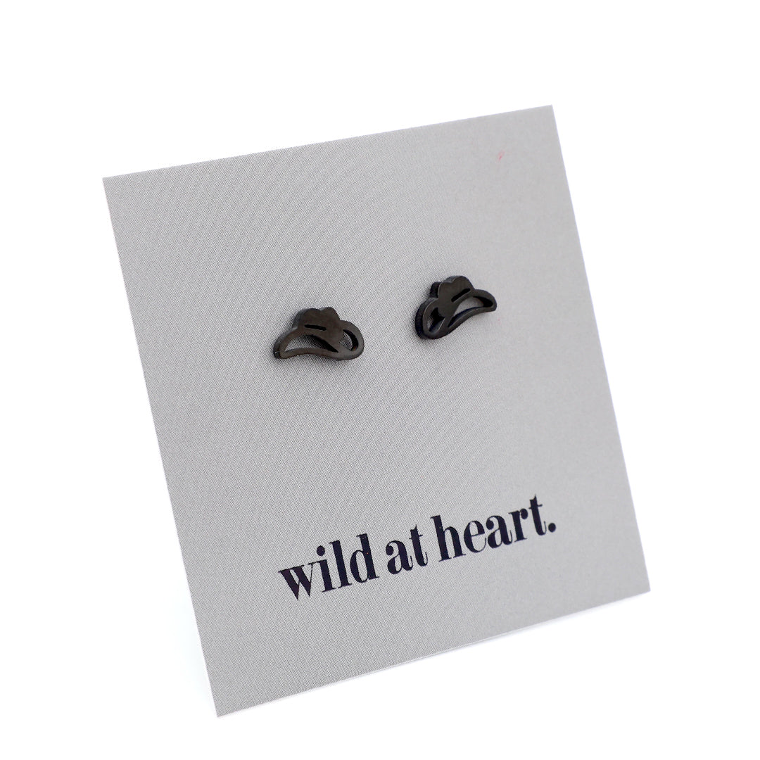 Black cowgirl hat earrings on a black card with 'wild at heart.' text