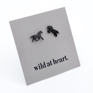 Black horse earrings on a black card with 'wild at heart.' text