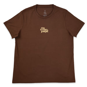 A brown short-sleeve crewneck t-shirt with a small gold script graphic on the left chest reading 'strong determined grateful'.