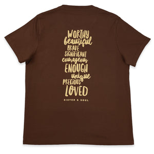 A brown short-sleeve t-shirt shown from the back, featuring a vertical stack of inspirational words in a textured beige font including 'WORTHY', 'BEAUTIFUL', 'BRAVE', 'SIGNIFICANT', 'COURAGEOUS', 'ENOUGH', 'UNIQUE', 'PRECIOUS', 'LOVED', and the brand name 'SISTER & SOUL' at the bottom.