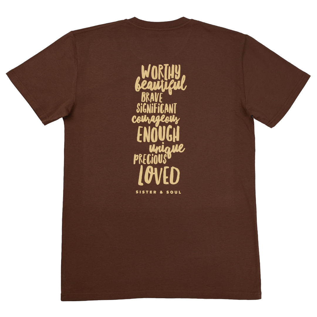 A brown short-sleeve t-shirt shown from the back, featuring a vertical stack of inspirational words in a light tan handwritten-style font, including 'WORTHY', 'BEAUTIFUL', 'BRAVE', 'SIGNIFICANT', 'COURAGEOUS', 'ENOUGH', 'UNIQUE', 'PRECIOUS', and 'LOVED', with 'SISTER & SOUL' printed below.