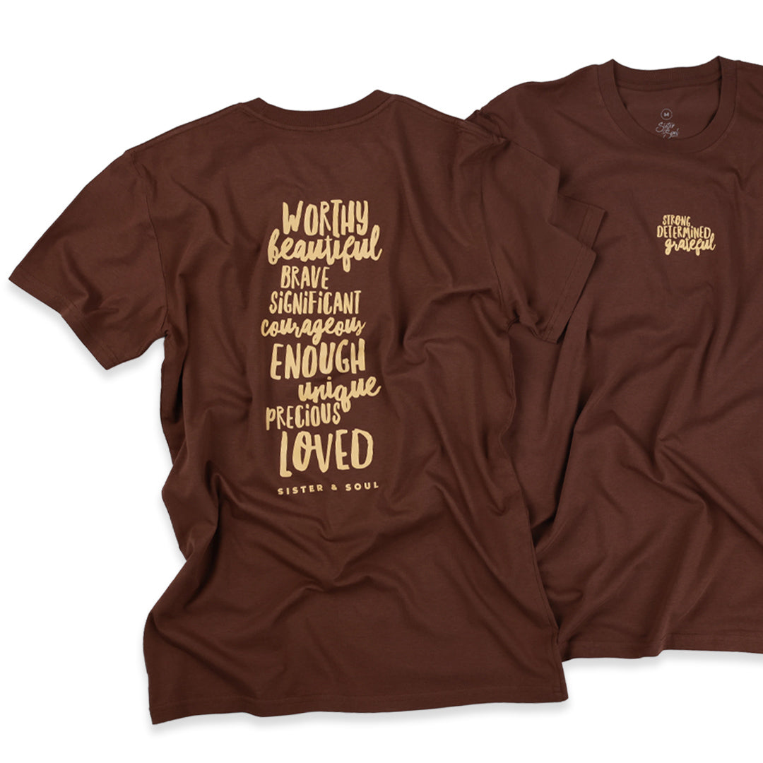 Two brown short-sleeve graphic T-shirts shown on a white background, with one shirt displaying a large vertical text print on the back and the other showing a smaller matching text print on the chest.