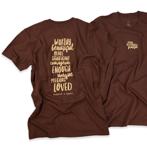 Two brown short-sleeve graphic T-shirts shown on a white background, with one shirt displaying a large vertical text print on the back and the other showing a smaller matching text print on the chest.
