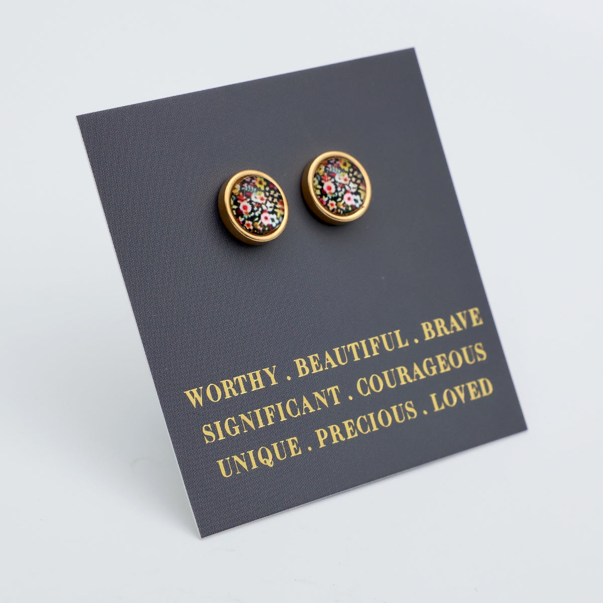Pair of floral stud earrings on a card with motivational phrases.