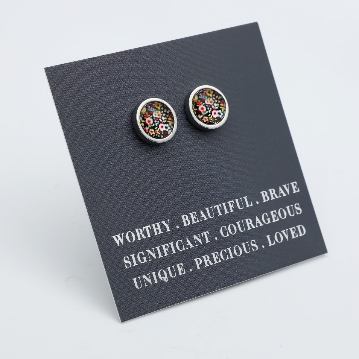 Pair of floral stud earrings on a card with motivational phrases.
