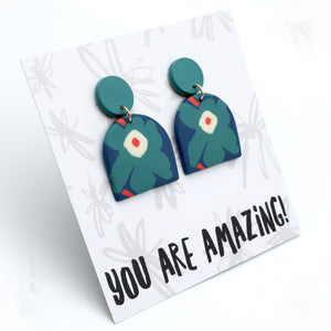 Green earrings on a card with 'YOU ARE AMAZING!' text