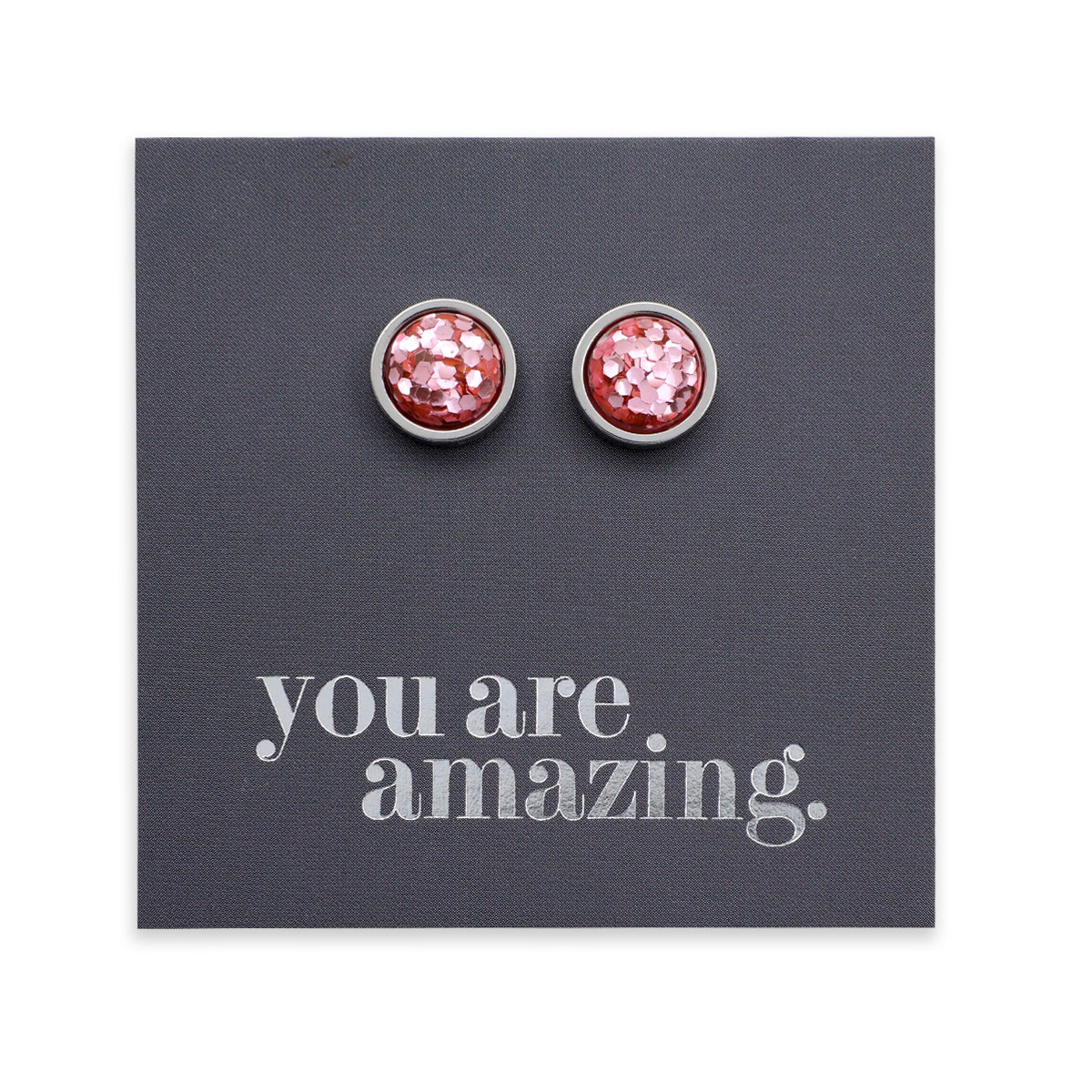 Pink glittery stud earrings on a gray card with 'you are amazing' text