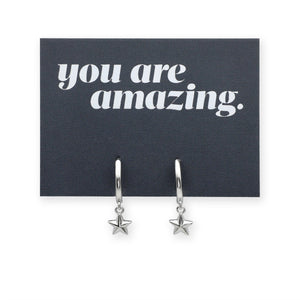 Silver star earrings on a card with 'you are amazing' text