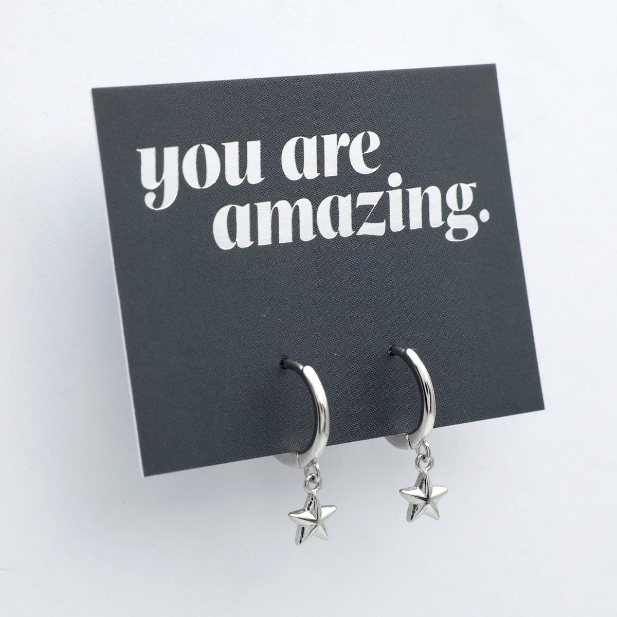Silver star earrings on a card with 'you are amazing' text