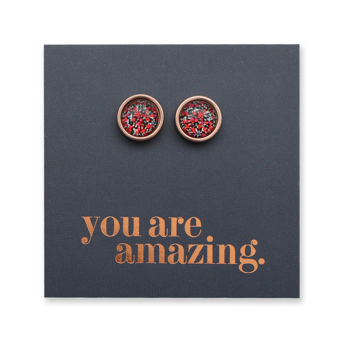 Pair of round earrings with red and gold design on a dark blue card with 'you are amazing' text.
