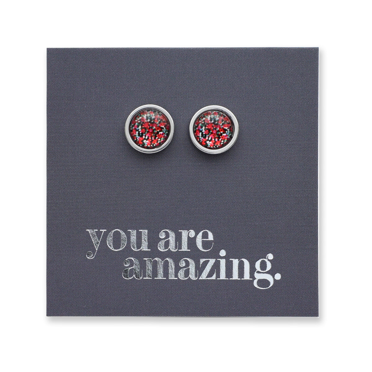 Silver earrings with red gemstones on a card that says 'you are amazing'.