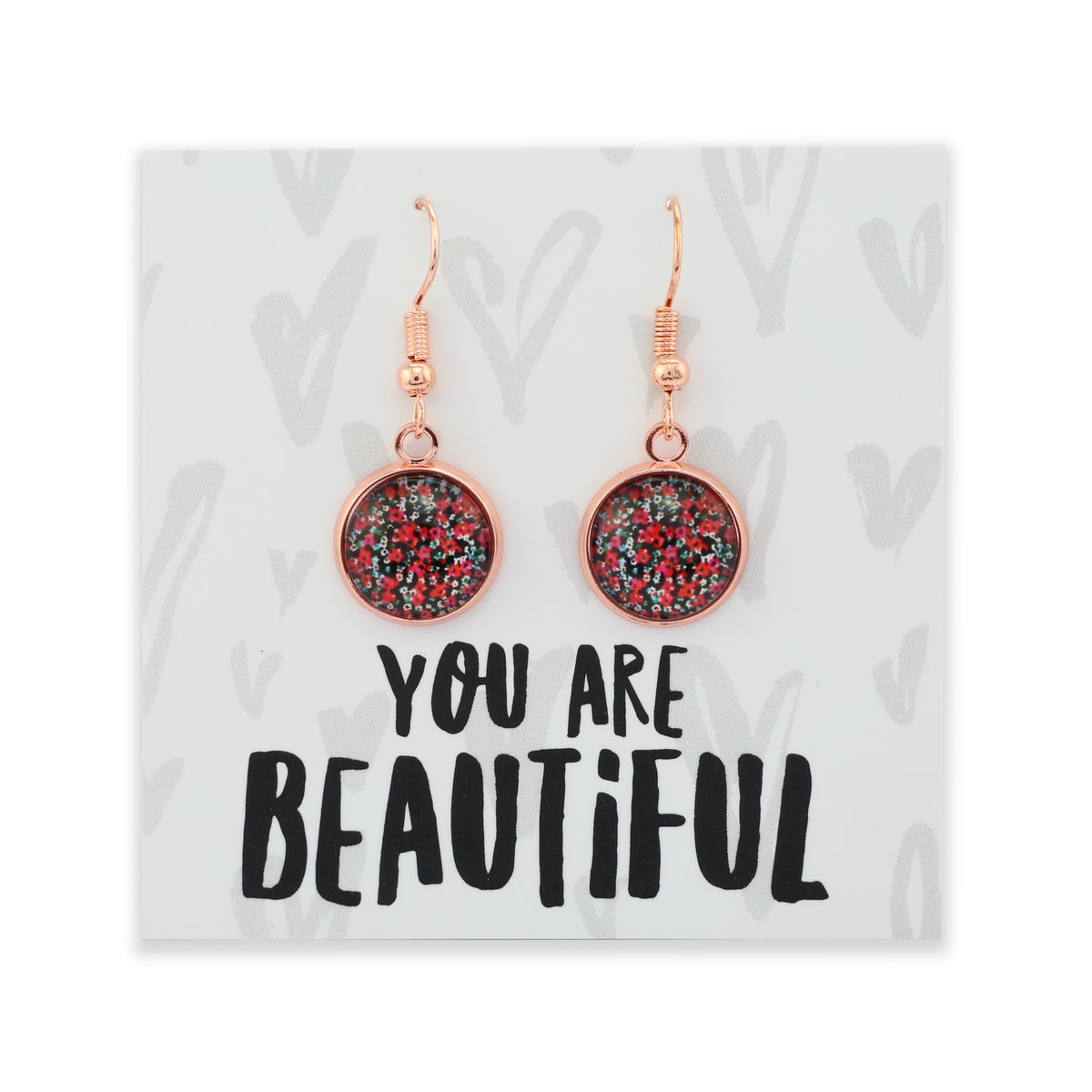 Earrings with glittery design on a card with 'You are Beautiful' text