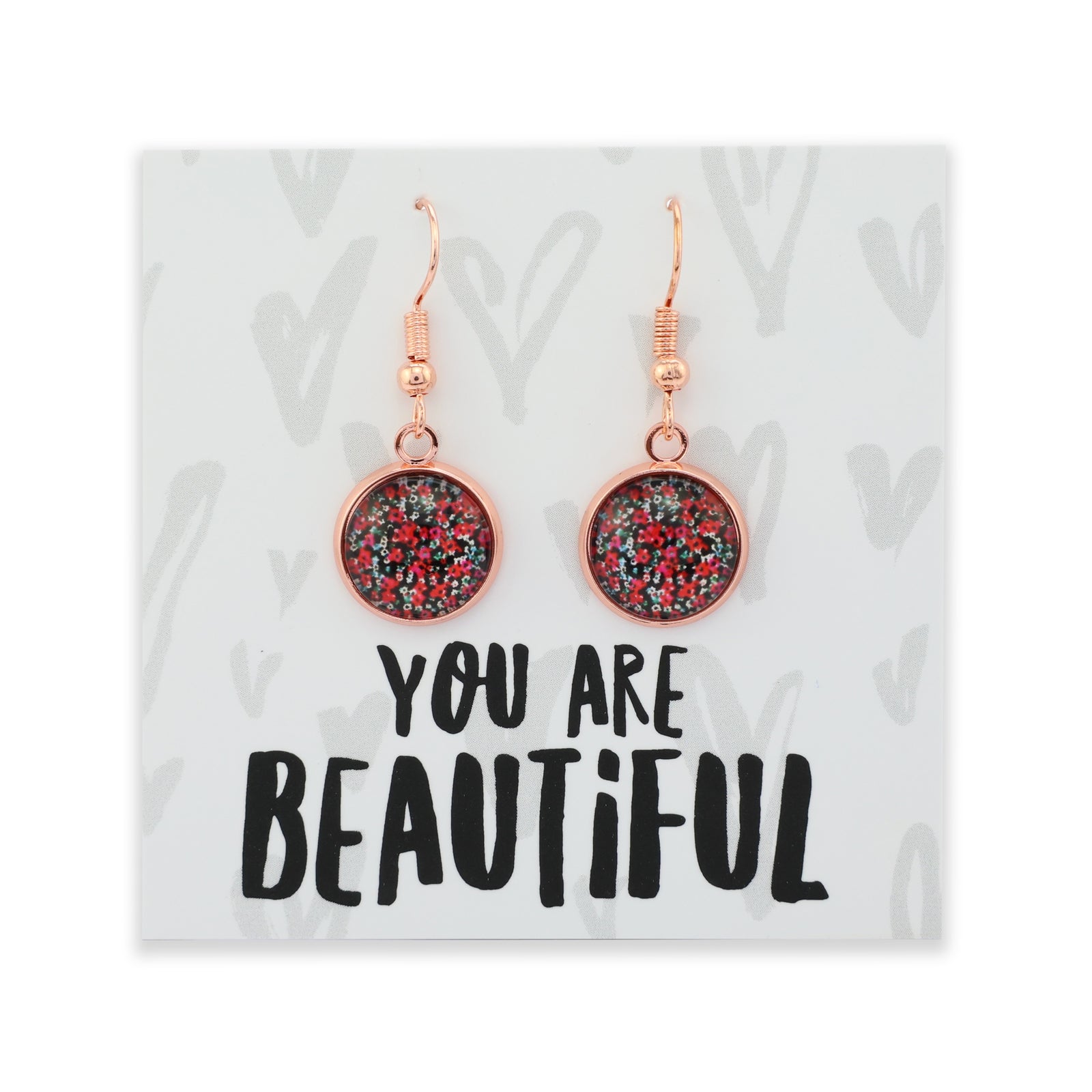 Earrings with glittery design on a card with 'You are Beautiful' text