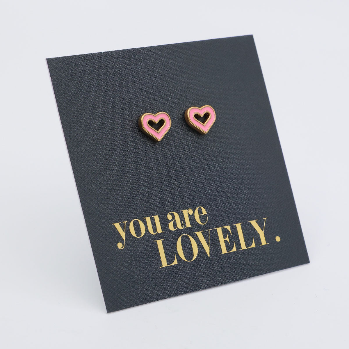 Heart-shaped earrings on a card with 'You are Lovely' text