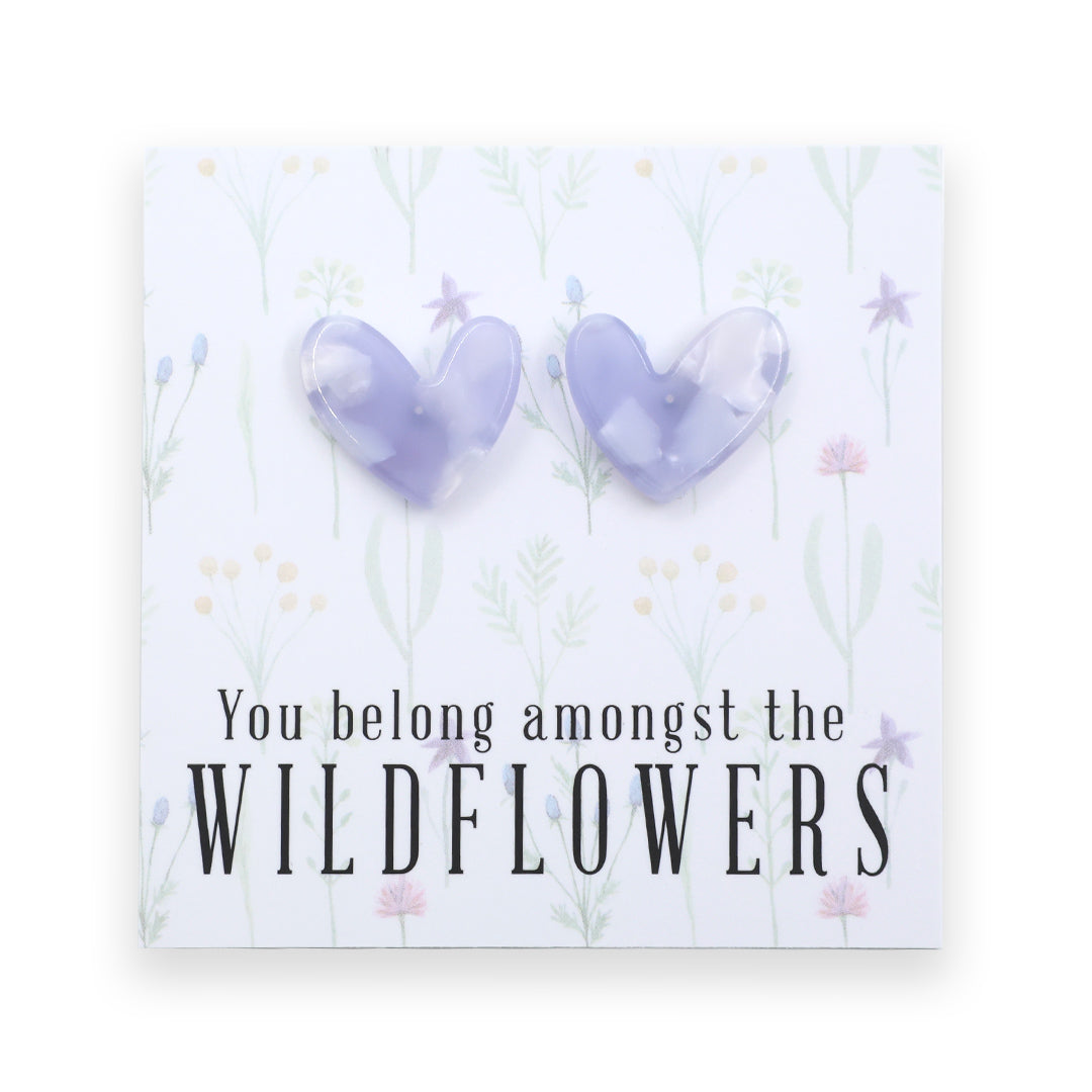 Heart-shaped earrings on a card with 'You belong amongst the wildflowers.' text