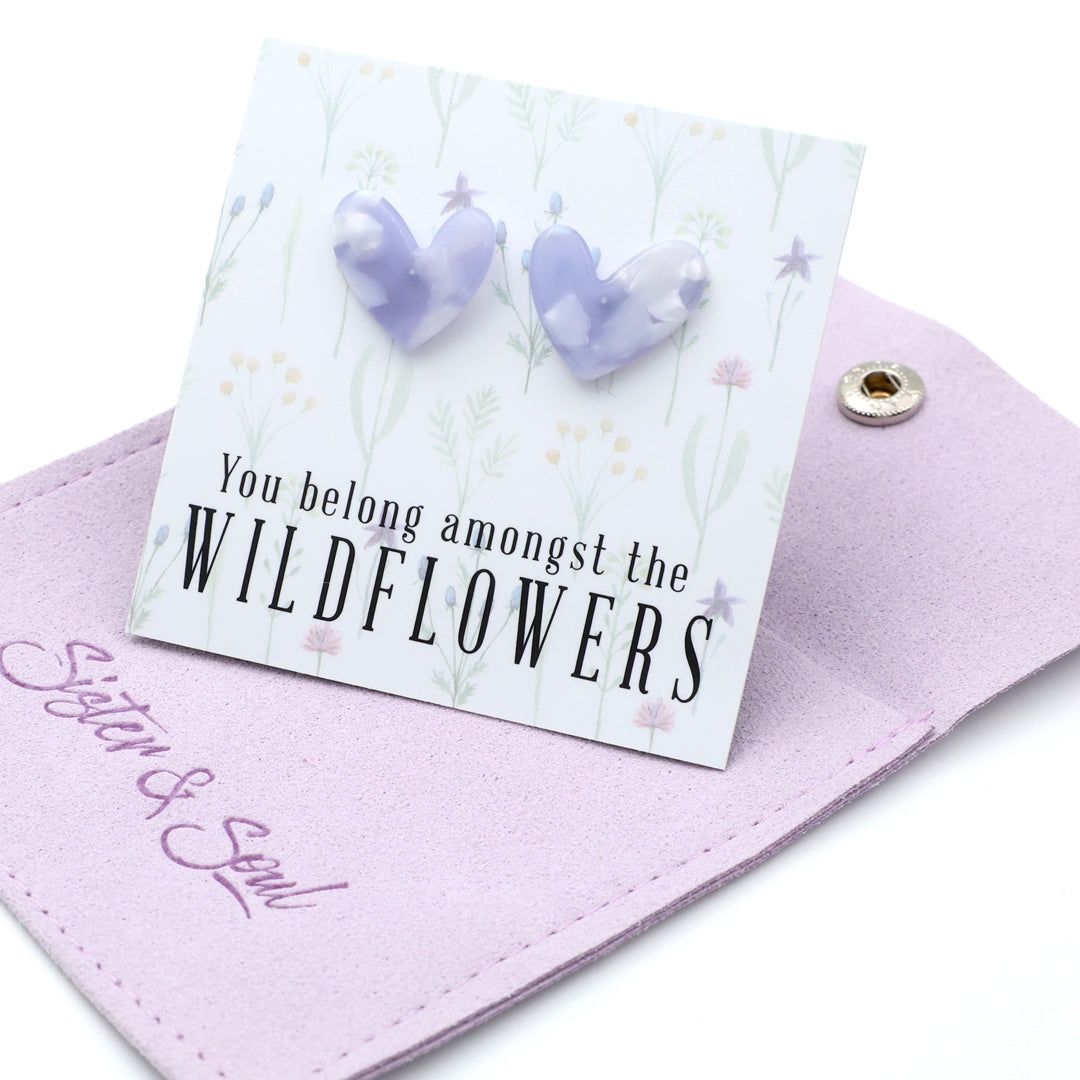 Heart-shaped earrings on a card with 'You belong amongst the wildflowers.' text