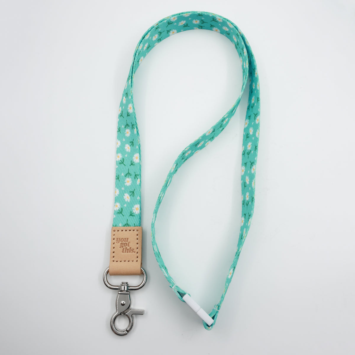 Full-length Aqua Daisies lanyard with a tan You Got This tab, silver-tone clasp and white breakaway fastening.