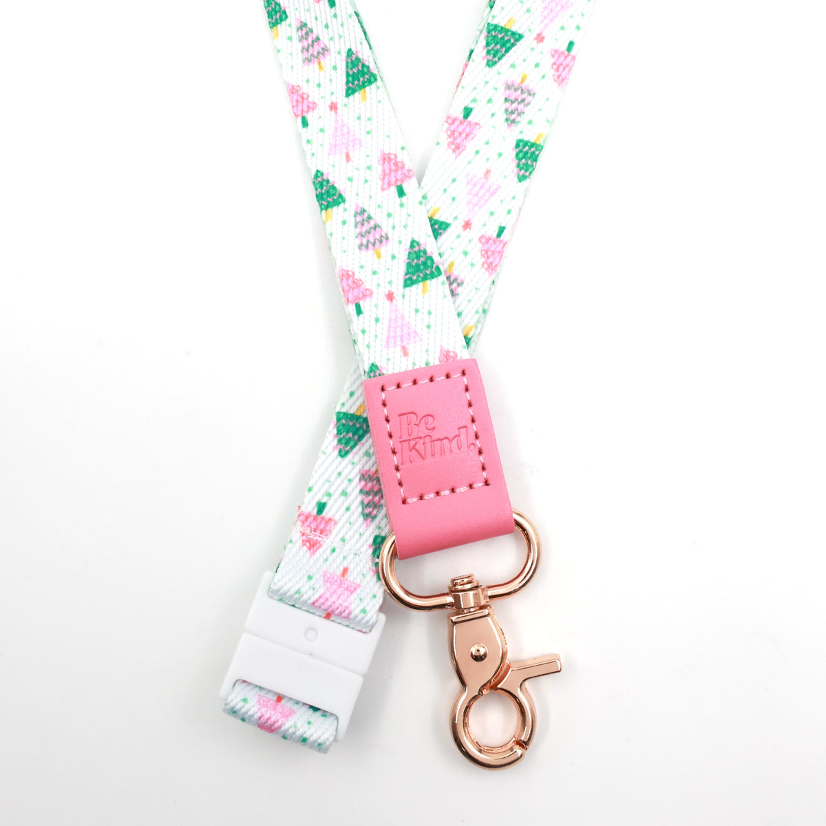 Christmas Delight lanyard with colourful Christmas trees, a pink Be Kind tab, gold-tone clasp and white breakaway fastening.