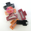 Hair accessories. 3 pack of hair claw clips in matte black, orange and raspberry.