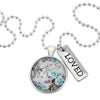 Teal floral print pendant necklace in bright silver with loved charm.