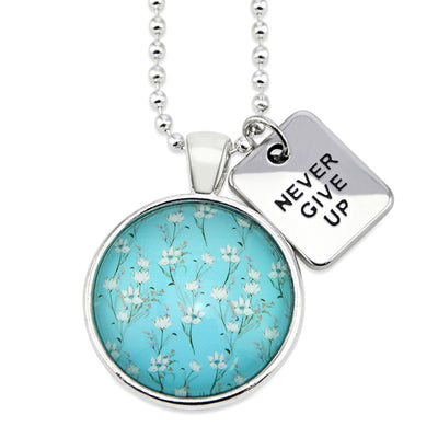 Teal floral print pendant necklace in bright silver with never give up charm.